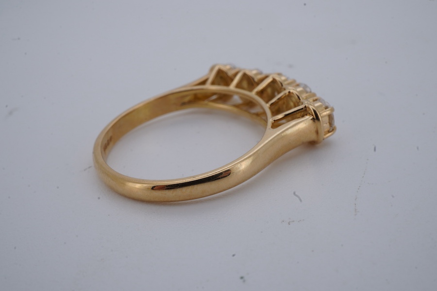 A five-stone diamond ring, claw-set with five oval diamonds totalling approximately 0.40 carats, mounted in gold, size M1/2, stamped 18K, gross weight approximately 3.5 grams